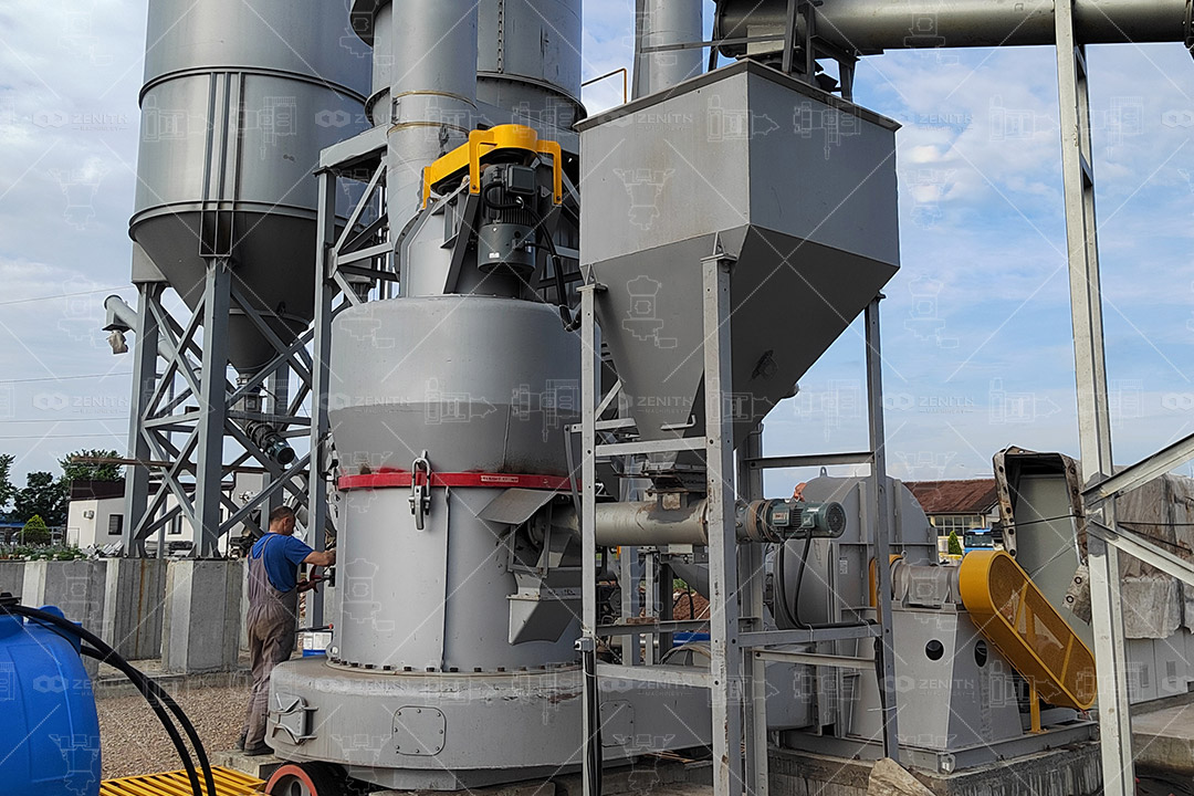 Close-up view of fine fluorite powder flowing from Zenith grinding mill cyclone collector